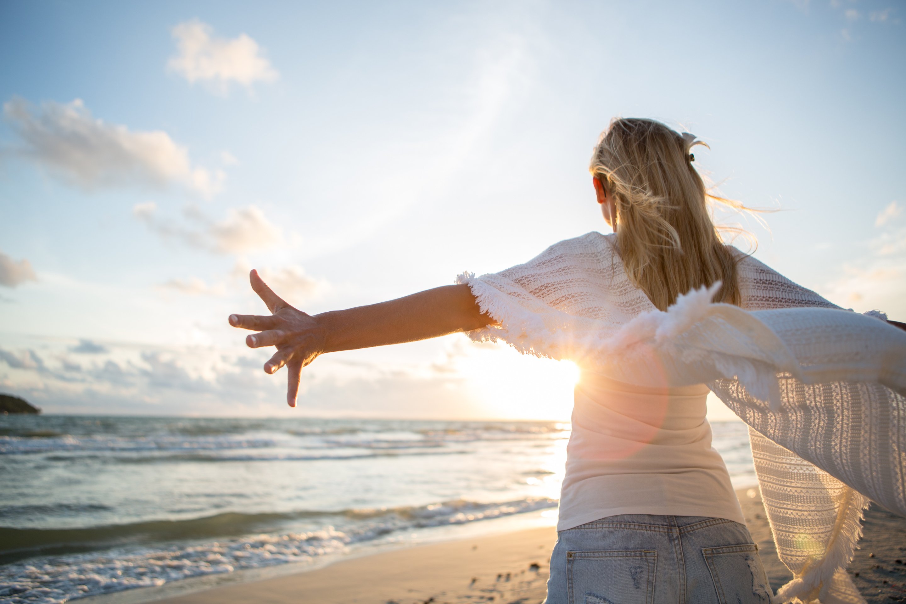 Young inspired woman by the sea